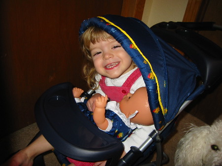 Hannah plays in her doll's stroller