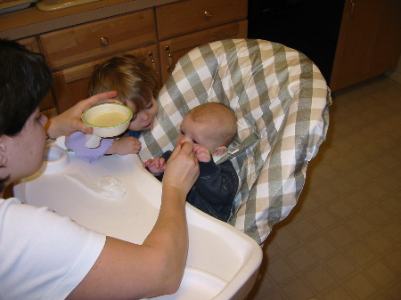 Hylton eating rice cereal for the first time